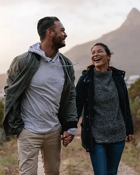 Couple laughing and holding hands