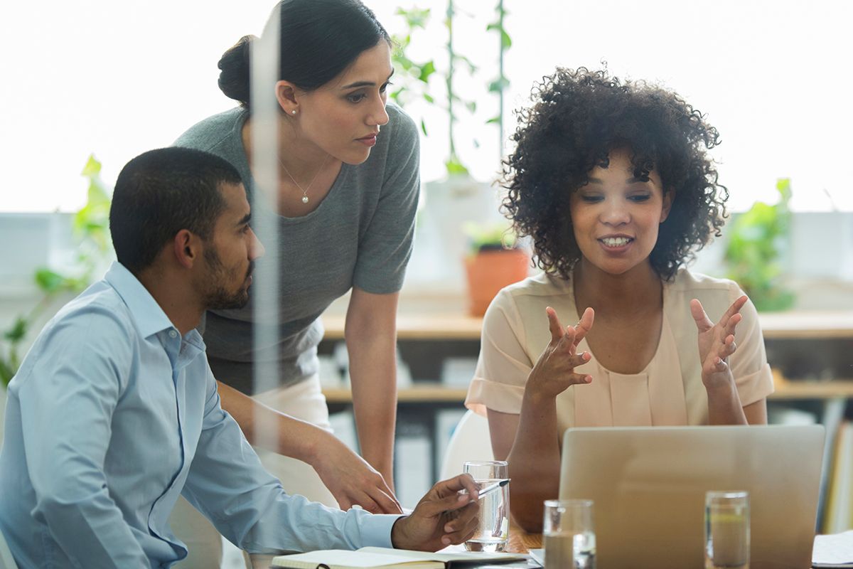 Multigender and multiethnic two women and a man discussing career strategies for physicians.